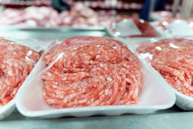 Raw minced meat close-up on the shelves of a hypermarket. Selective focus