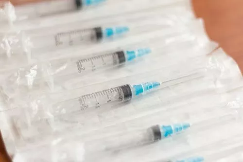new disposable injection syringes in the package, close-up, selective focus