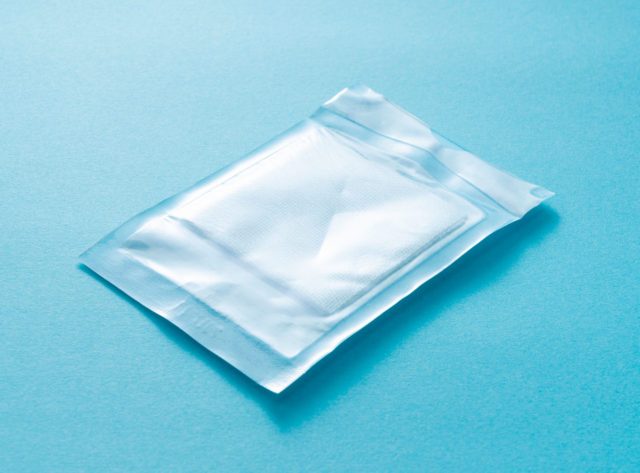 Individually wrapped gauze on a blue background